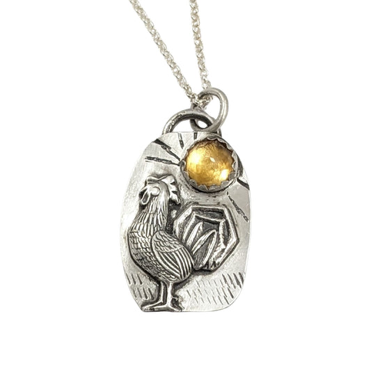 Sterling silver pendant with a three dimensional rooster and a yellow citrine gemstone on a textured background