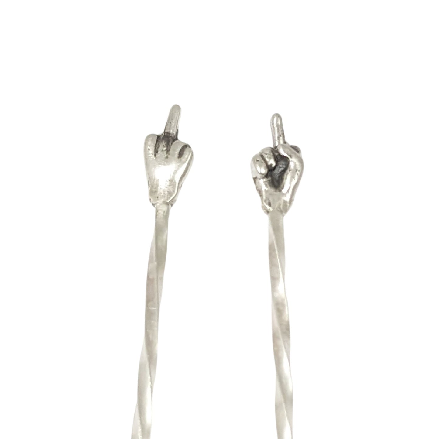 Pair of sterling silver cocktail picks. At the top is a hand with the middle finger raised, ie flipping the bird. One hand faces toward you, the other faces away.