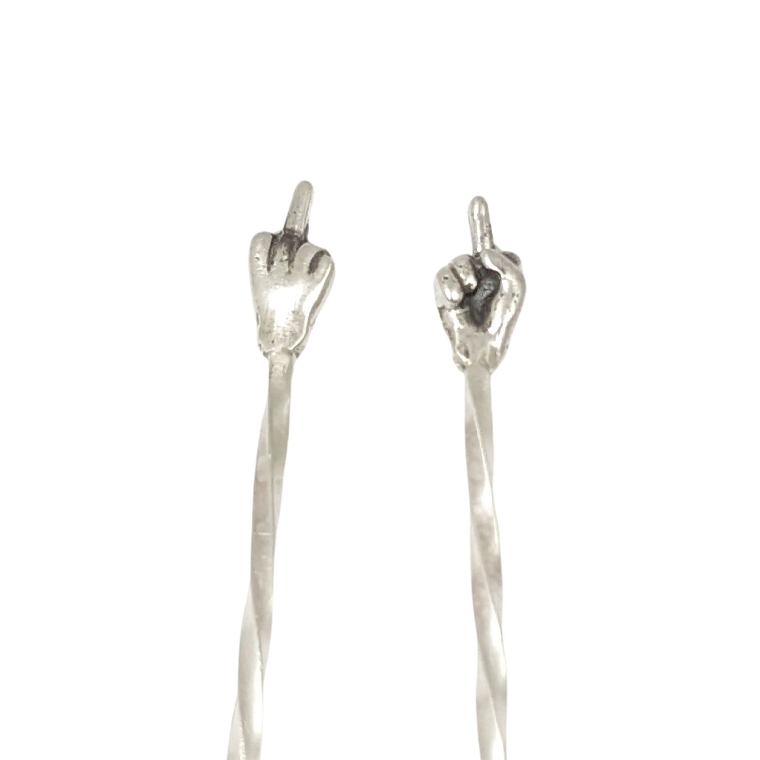 Pair of sterling silver cocktail picks. At the top is a hand with the middle finger raised, ie flipping the bird. One hand faces toward you, the other faces away.
