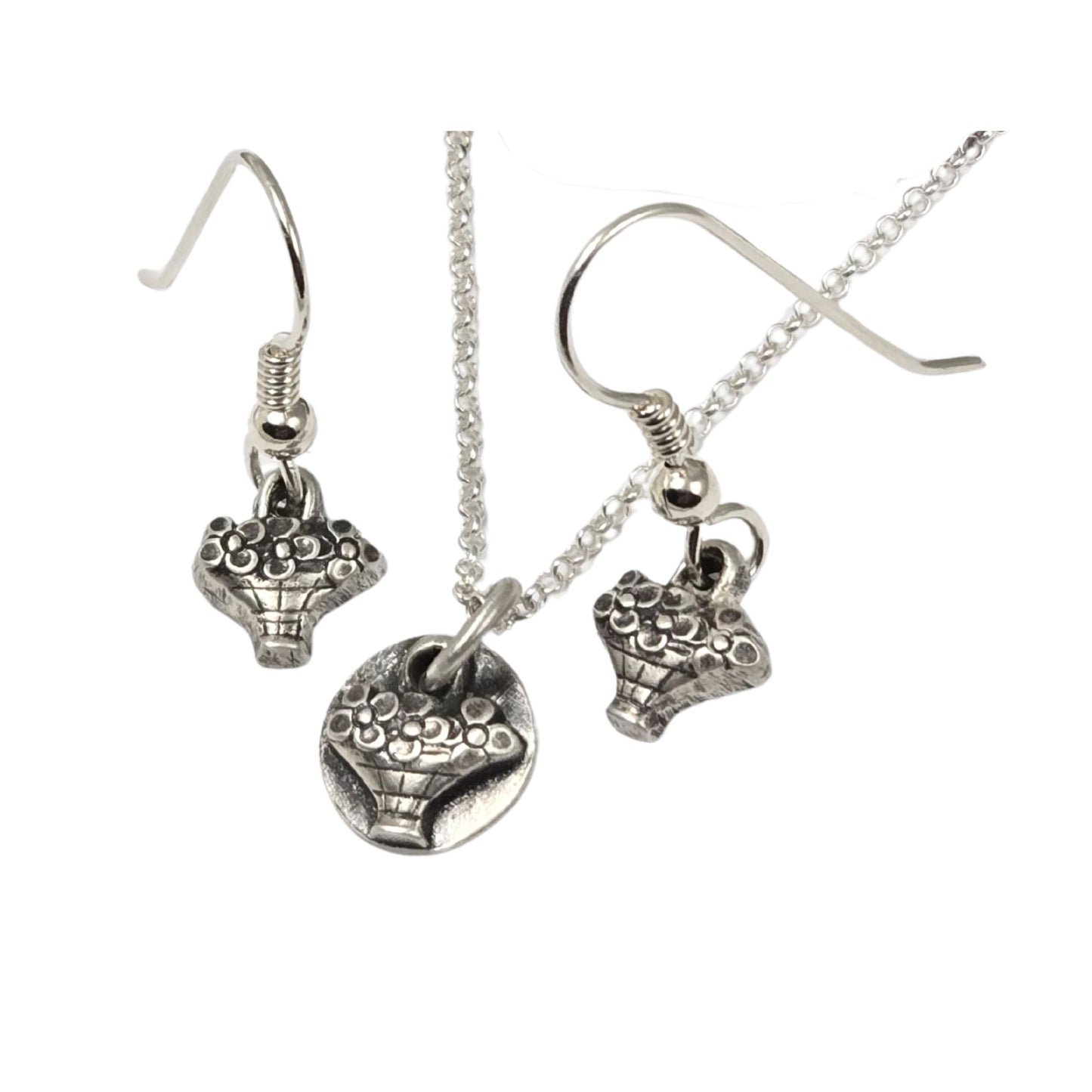 Earrings and necklace, each with a tiny hand basket full of flowers. All are silver.