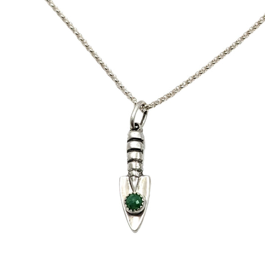 Three dimensional sterling silver garden hand trowel pendant with a faceted green chrysoprase gemstone on the trowel handle.