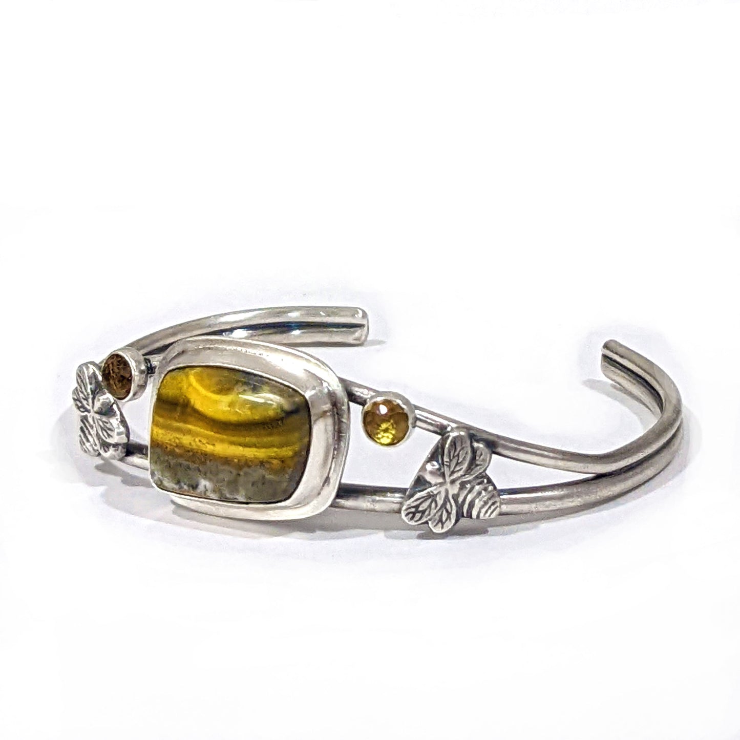 Side view of Sterling Silver Bumblebee Jasper cuff bracelet with two sterling silver bees and two rose cut citrine gemstones