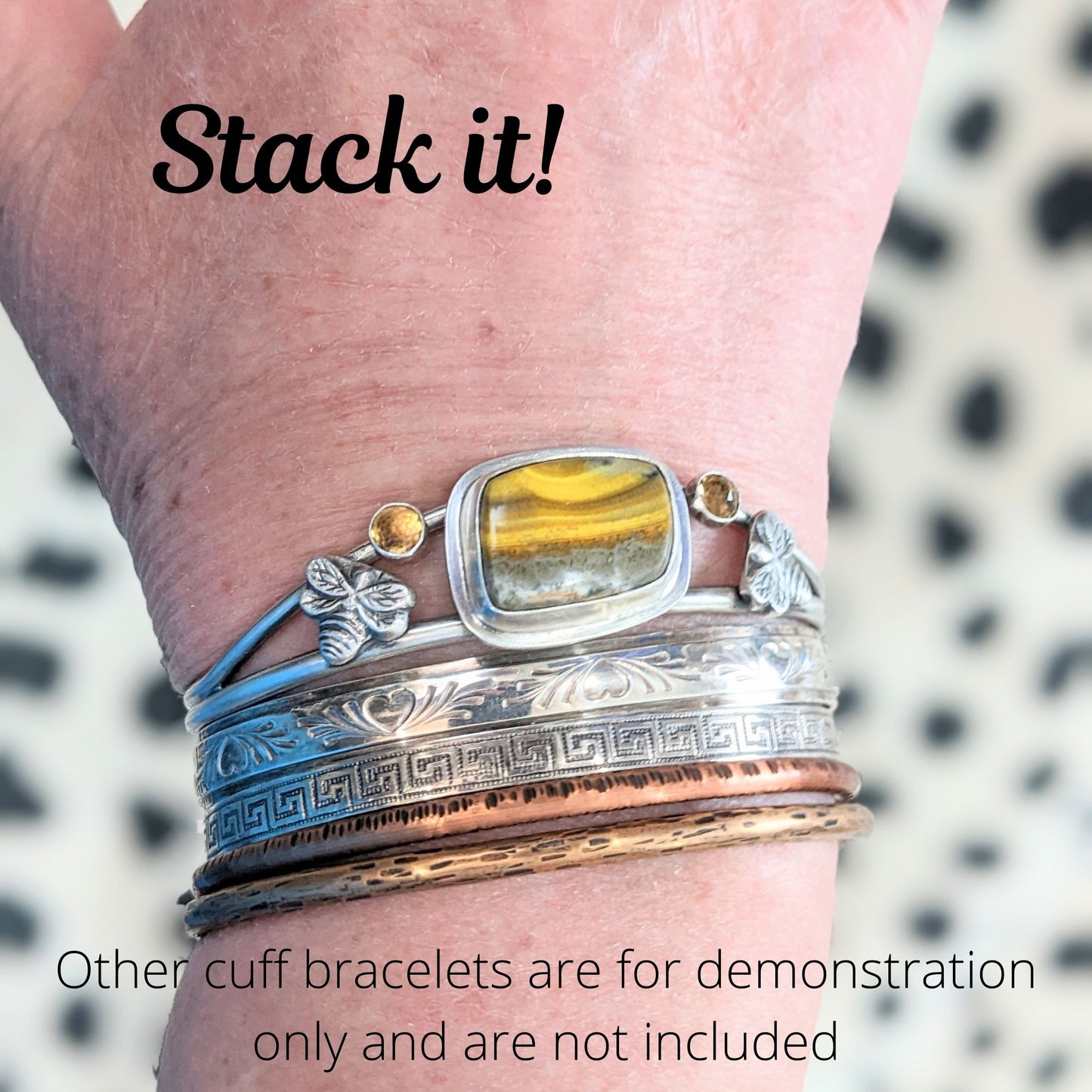 Sterling Silver Bumblebee Jasper cuff bracelet with two sterling silver bees and two rose cut citrine gemstones. Modeled with other cuff bracelets to demonstrate how cuff bracelets can be stacked.