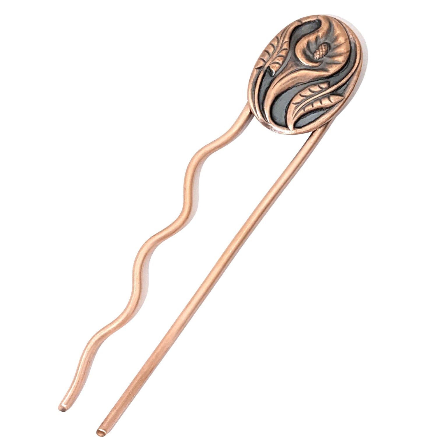 Full view of Copper hair fork with a calla lily flower design. Shows the copper forks. The Left fork has five bends to form a squiggle shape. The right fork is straight. Large oval copper piece with a single calla flower in the middle. A stem and leaf facing upward on the left side of the oval, and one facing downward on the right side of the oval. 