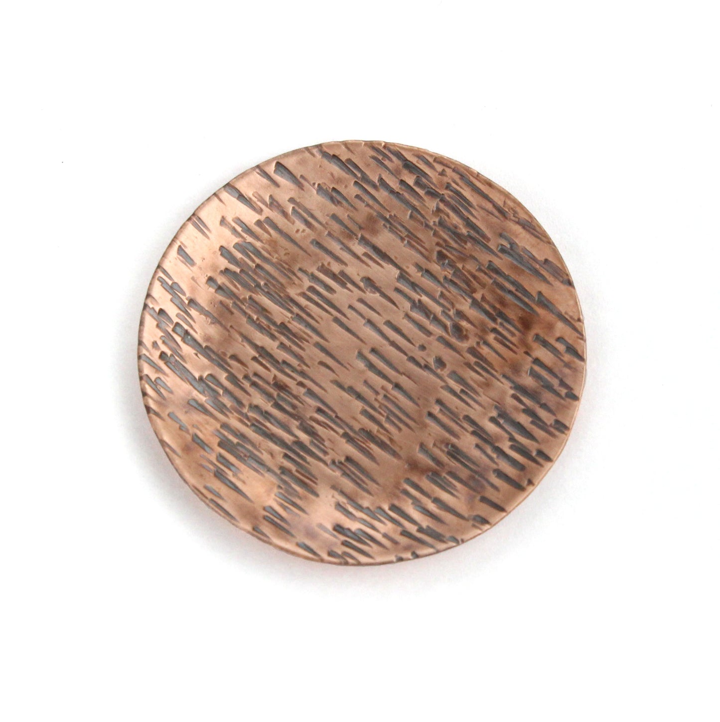 Small copper ring jewelry or trinket dish with a hammered texture resembling birch bark. The edges are curved up to form a shallow bowl.