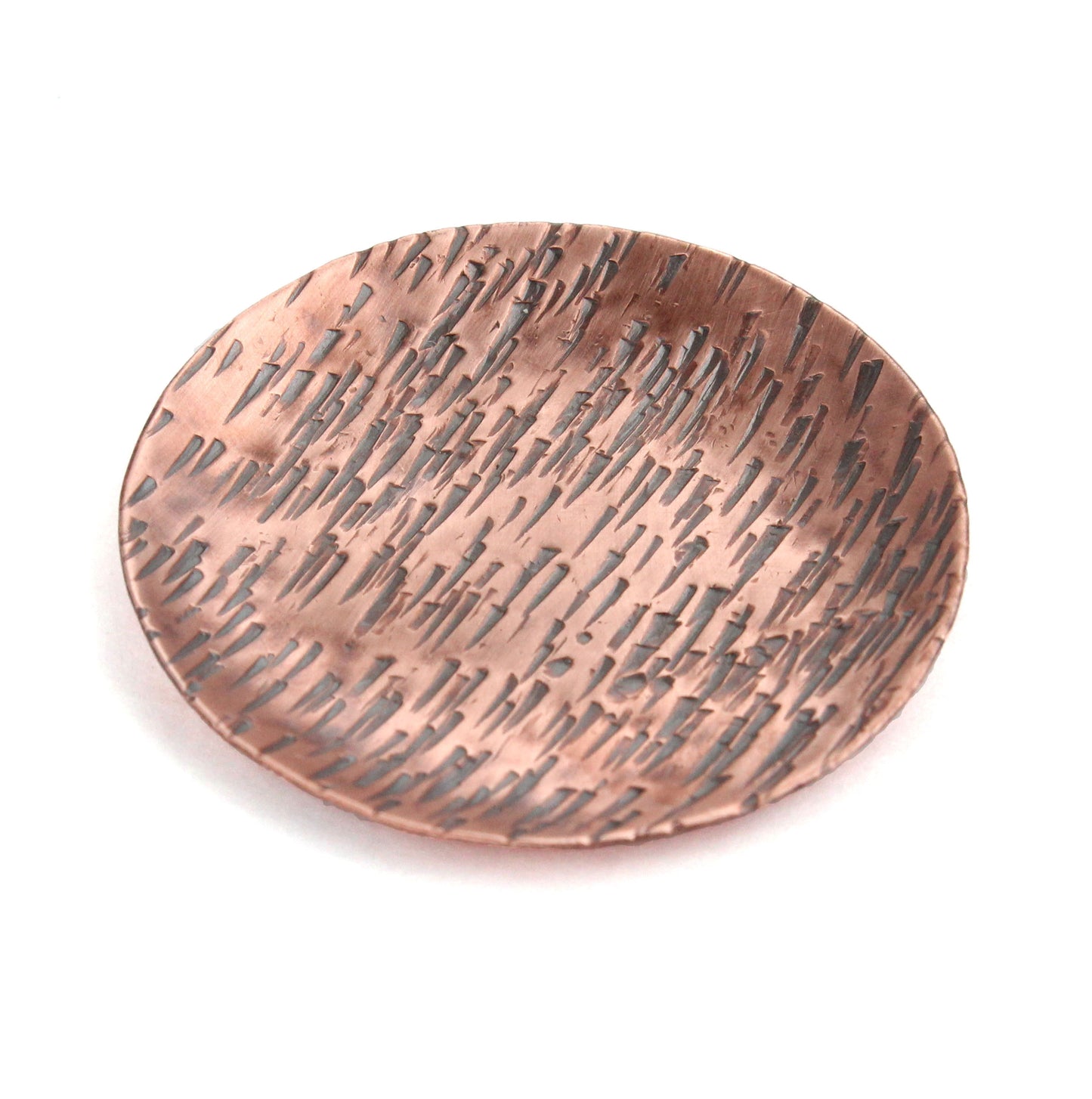 Small copper ring jewelry or trinket dish with a hammered texture resembling birch bark. The edges are curved up to form a shallow bowl.