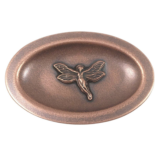Oval copper ring dish. In the middle is a three dimensional fairy in flight. Her wings have detailed webbing pattern and you can see the draping on her dress.  The dish has a small lip around the edge.