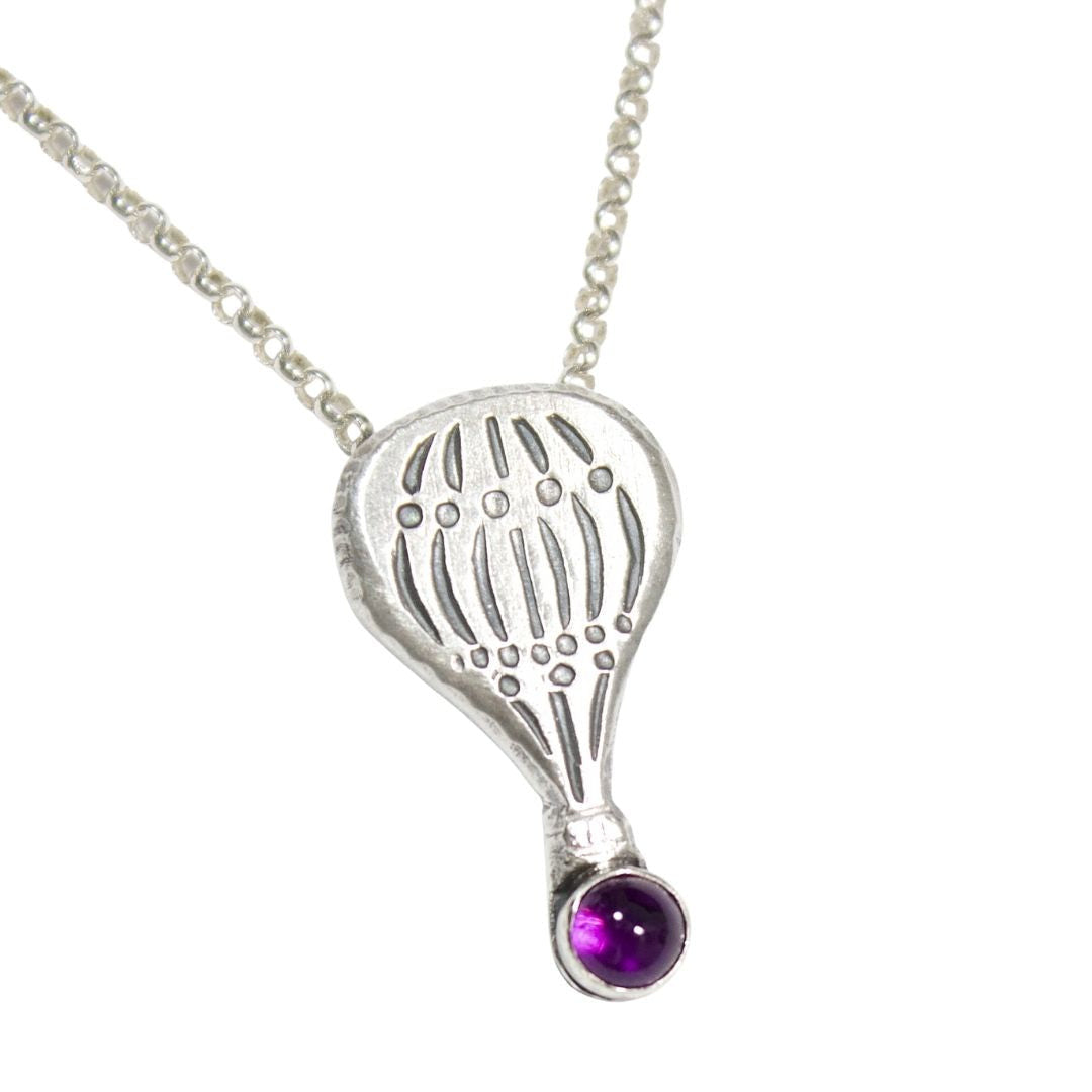 Hot air balloon shaped sterling silver pendant with a gemstone cabochon placed where the basket would be.  Shown with an amethyst.