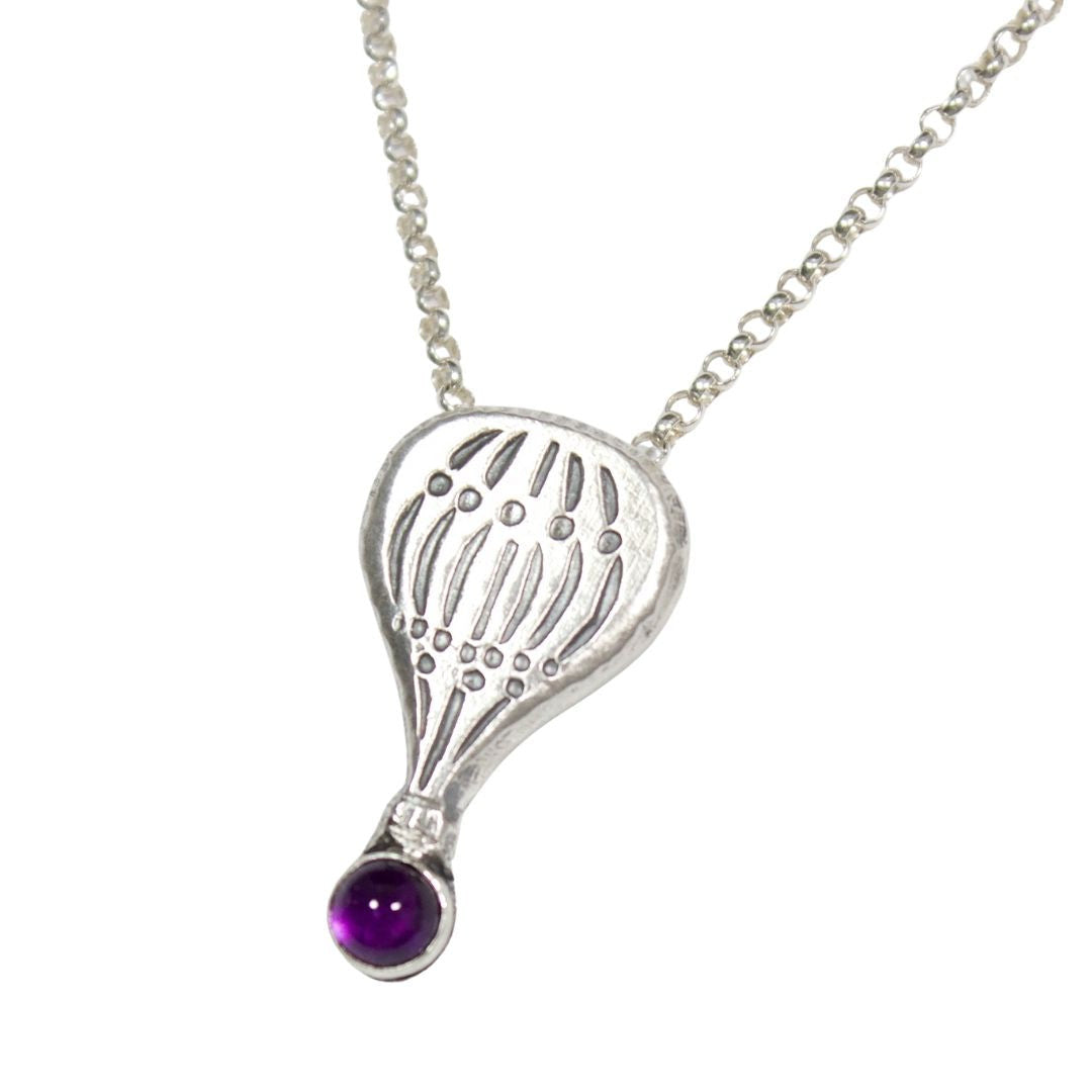 Hot air balloon shaped sterling silver pendant with a gemstone cabochon placed where the basket would be.  Shown with an amethyst.