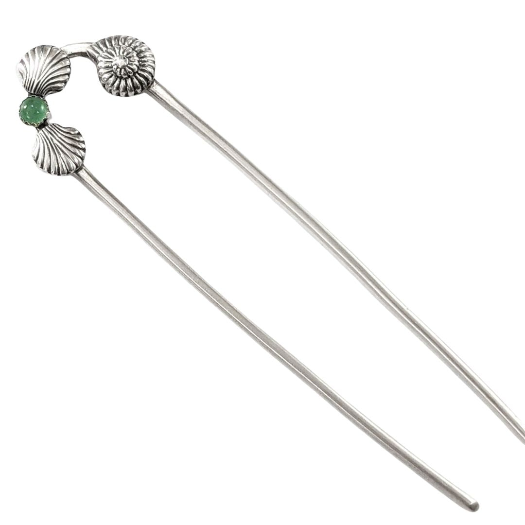 Sterling silver hair fork with three seashells and a green aventurine gemstone. Two of the seashells are scallop shaped and one is like a nautilus or ammonite.