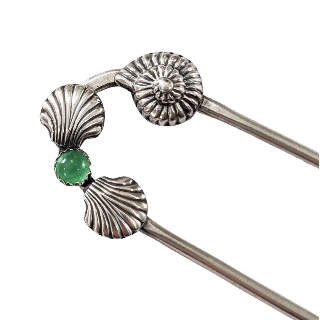 Sterling silver hair fork with three seashells and a green aventurine gemstone. Two of the seashells are scallop shaped and one is like a nautilus or ammonite.