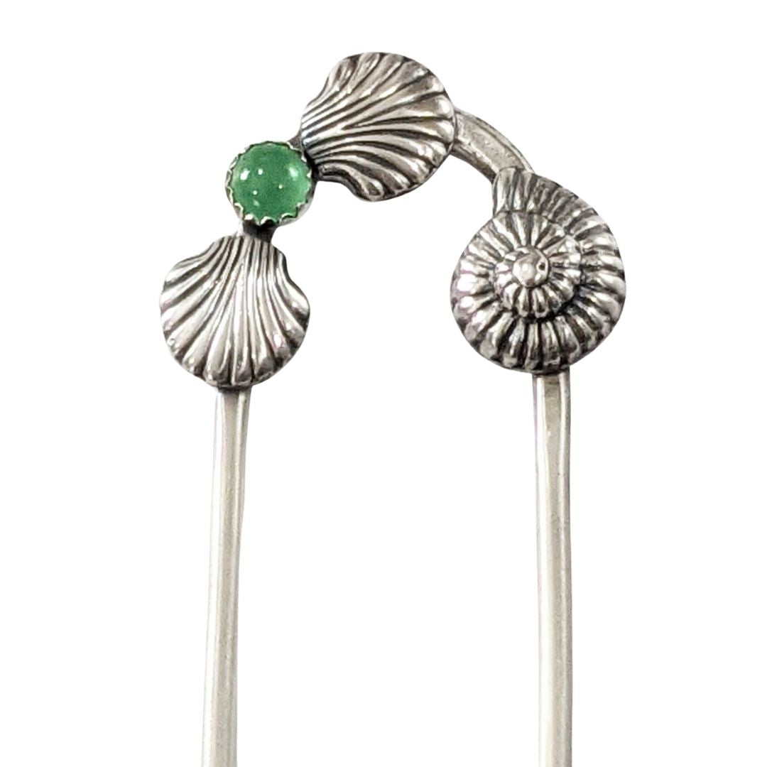 Sterling silver hair fork with three seashells and a green aventurine gemstone. Two of the seashells are scallop shaped and one is like a nautilus or ammonite.