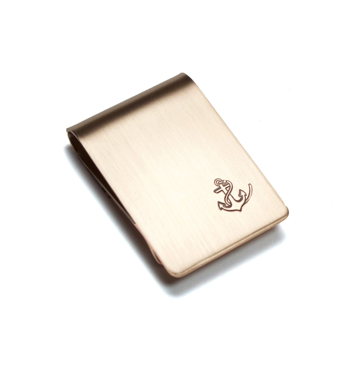 Anchor and Rope Money Clip. A small money clip with a stamped image of a boat anchor wrapped in a length of rope. The stamped design is darkened (oxidized). The money clip is shown in bronze metal.