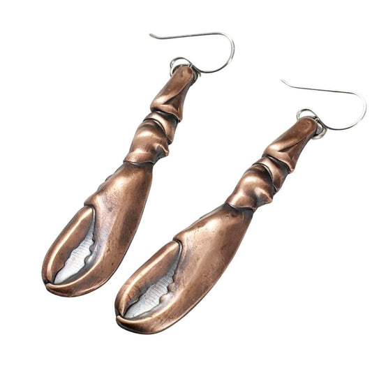 Copper earrings in the shape of a lobster claw. The claws are three dimensional and are on sterling silver ear wires